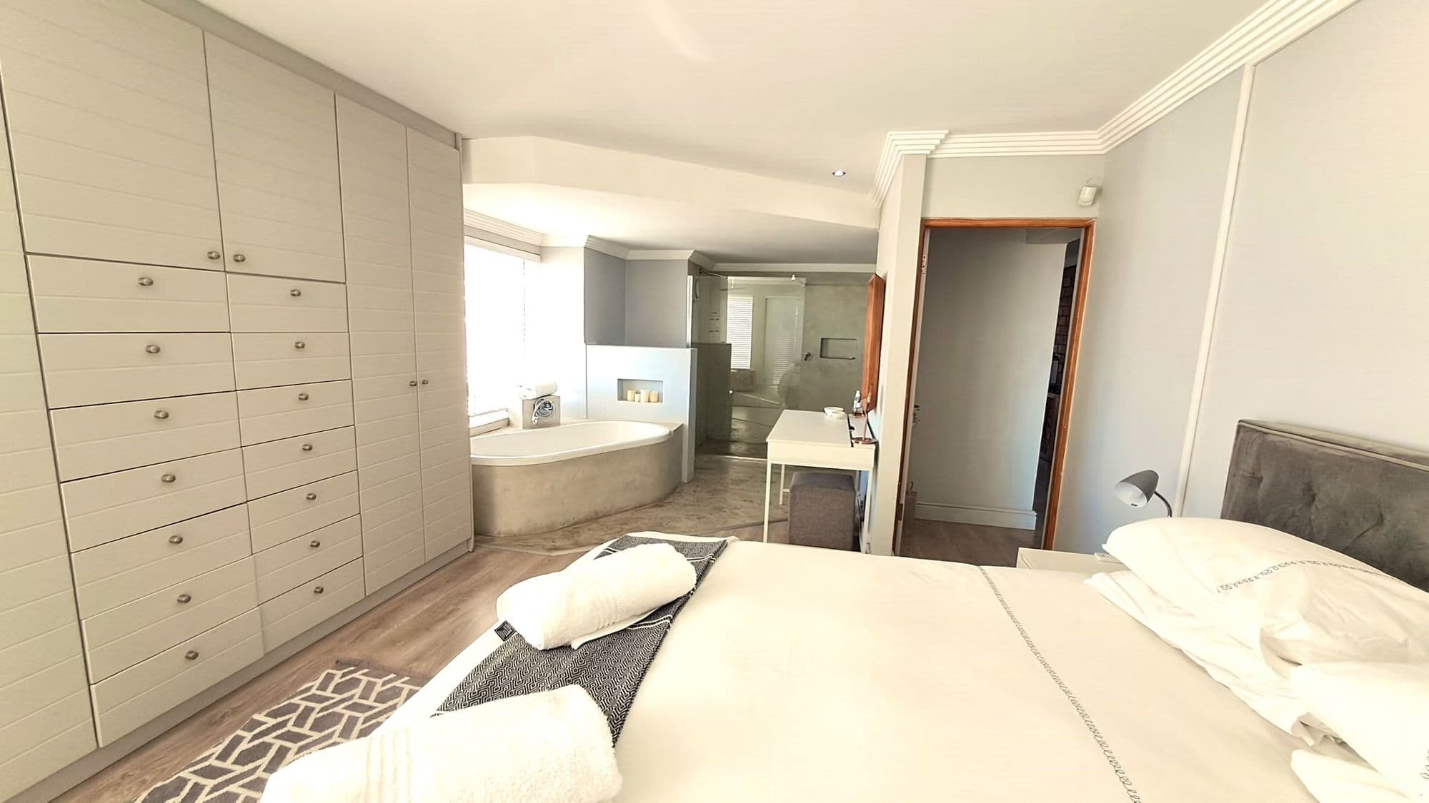 Main bedroom with king bed, built-in wardrobe and en-suite corner bath