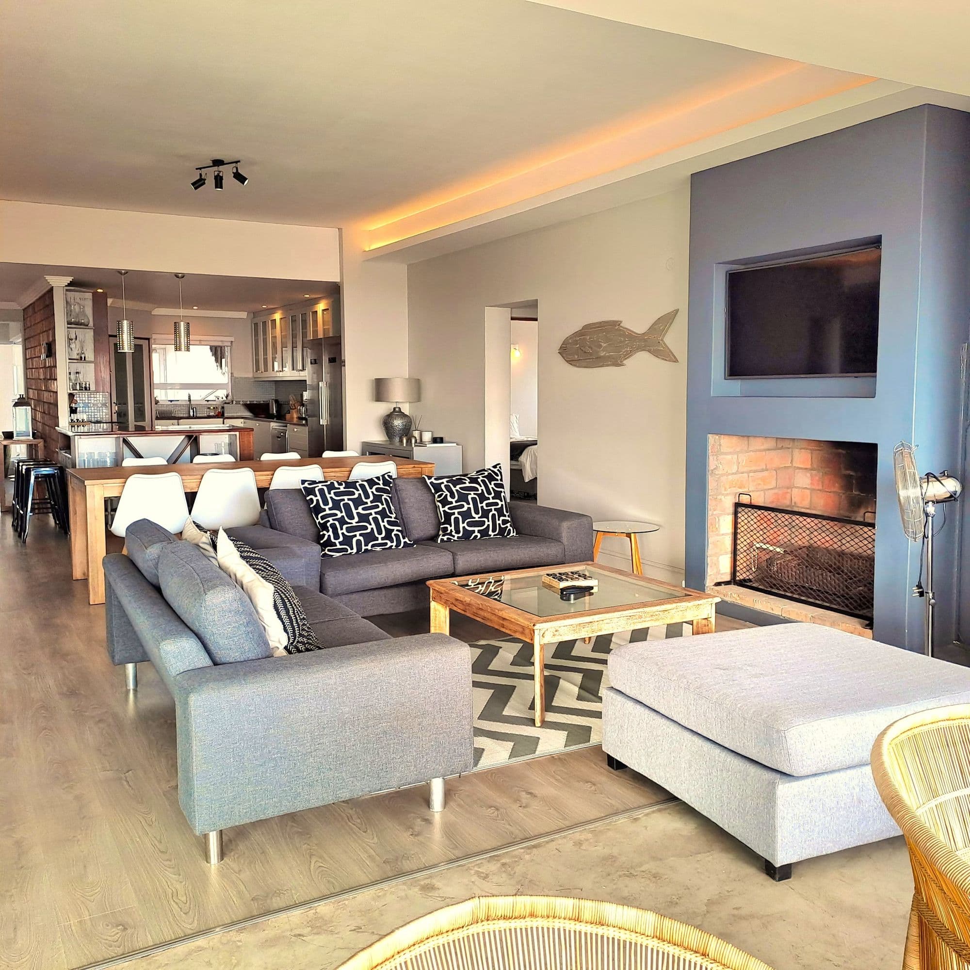 Living room with fireplace and sea views through the open-plan layout