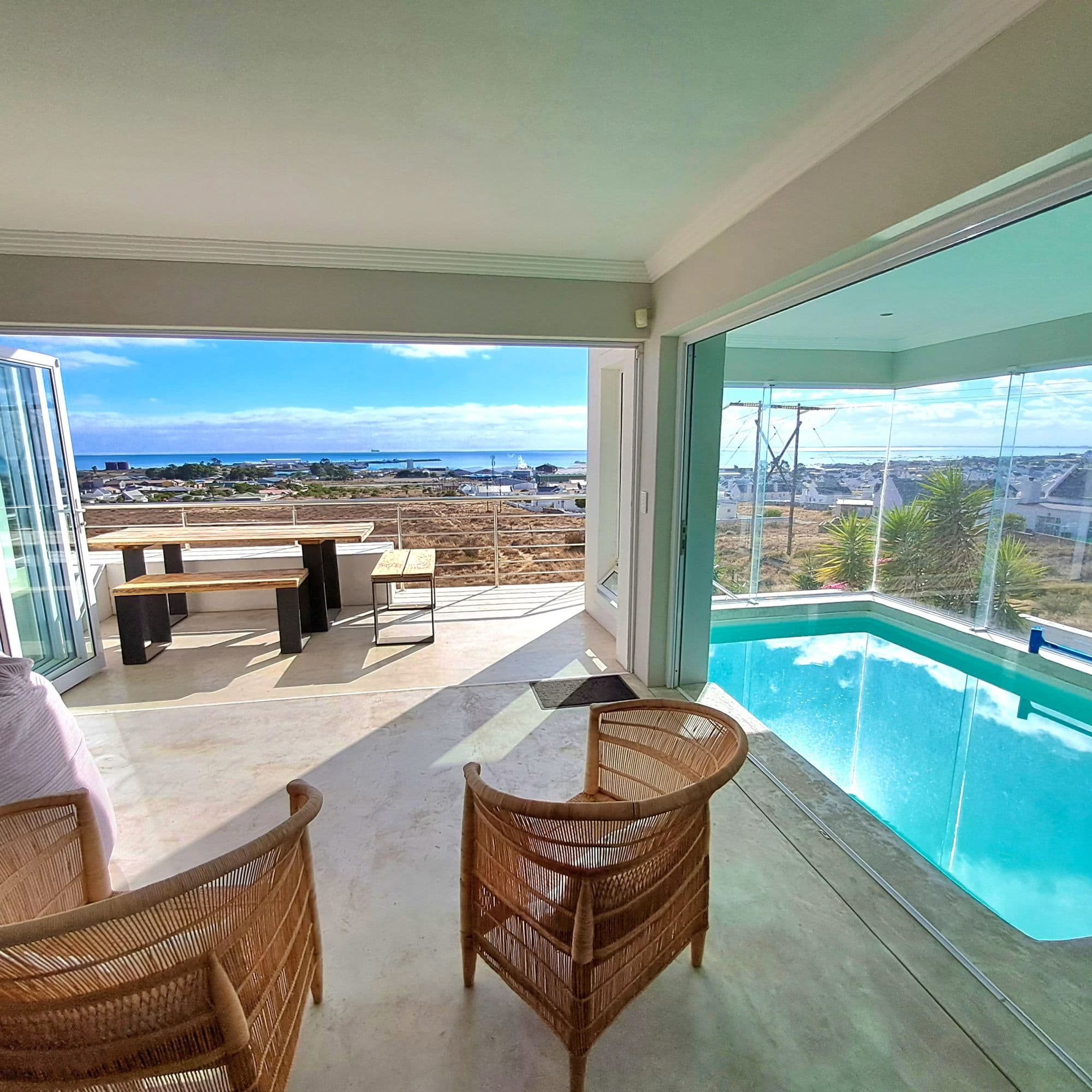 Indoor-outdoor living: the pool room opens onto the patio dining area and the bay