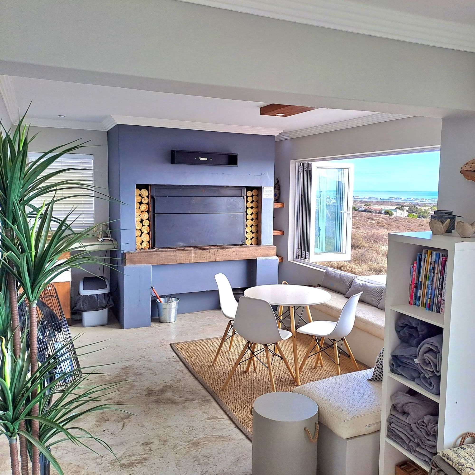 A family lounge nook with fireplace and sea view